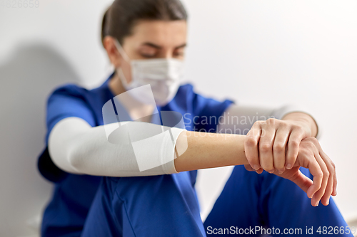 Image of sad doctor or nurse in protective face mask
