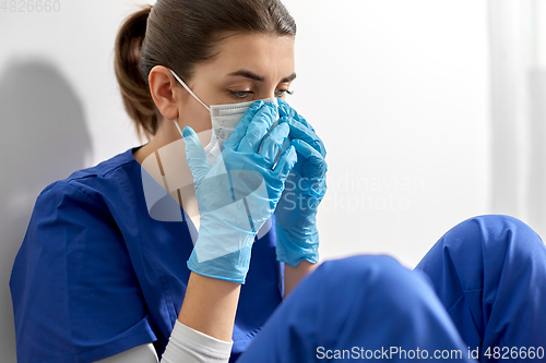 Image of sad doctor or nurse in protective face mask