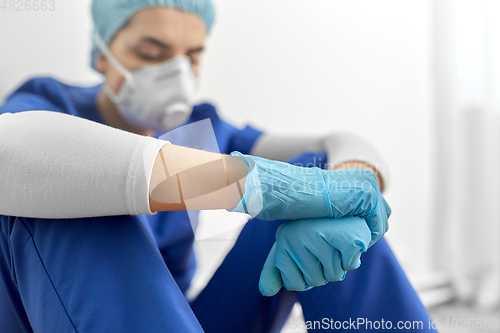 Image of sad doctor or nurse in protective face mask