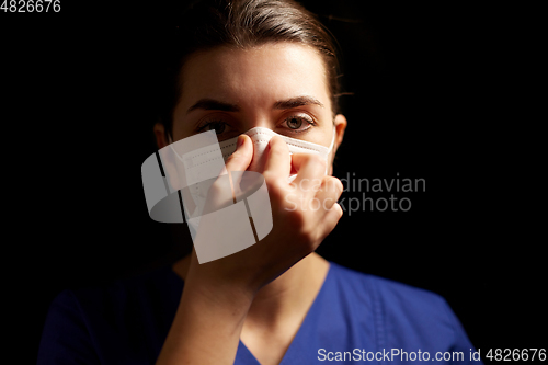 Image of female doctor or nurse in medical face mask