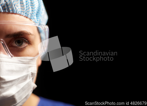 Image of female doctor or nurse in goggles and face mask