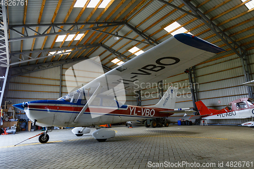 Image of outdoor shot of small plane standing in shed