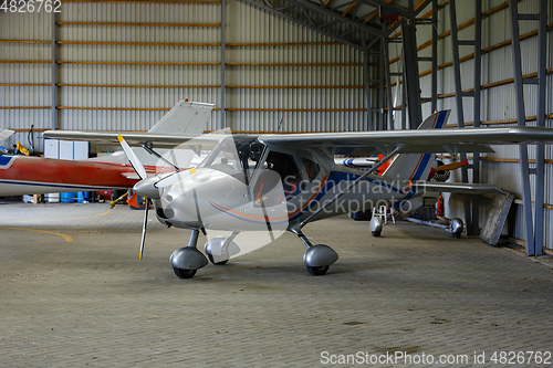 Image of outdoor shot of small plane standing in shed