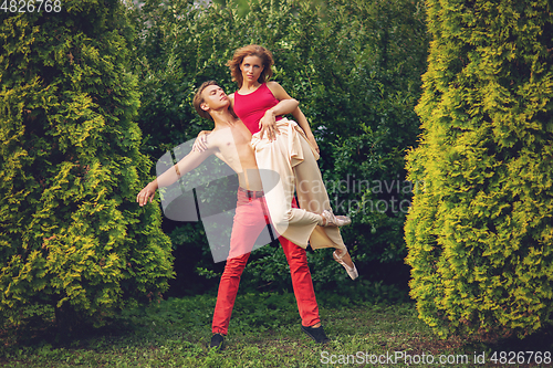Image of beautiful modern ballet couple dancing in summer outdoors
