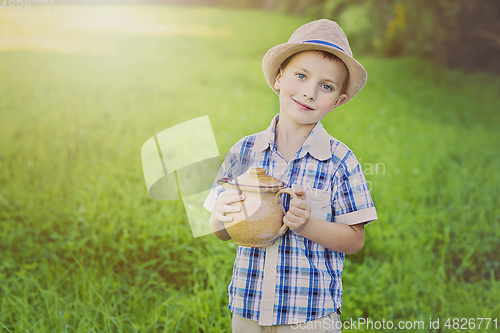 Image of handsome little boy with jug