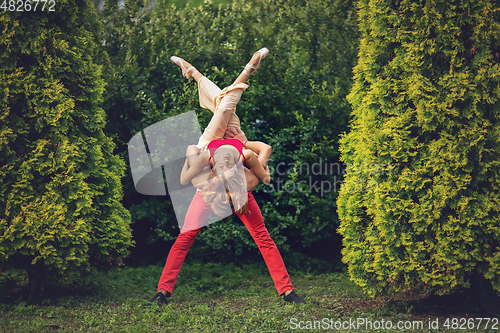 Image of beautiful modern ballet couple dancing in summer outdoors