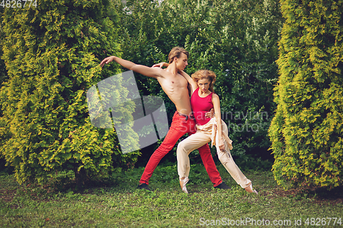 Image of beautiful modern ballet couple dancing in summer outdoors