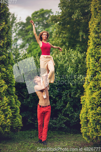 Image of beautiful modern ballet couple dancing in summer outdoors