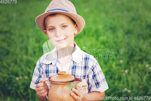 Image of handsome little boy with jug