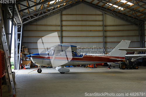 Image of outdoor shot of small plane standing in shed