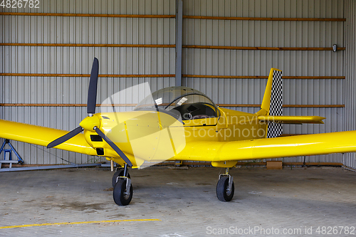 Image of outdoor shot of small plane standing in shed