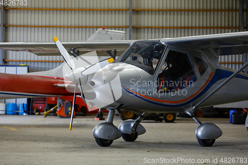 Image of outdoor shot of small plane standing in shed