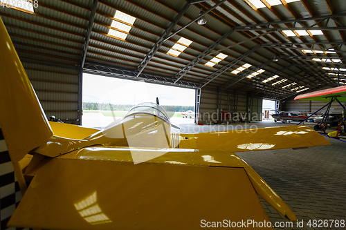Image of outdoor shot of small plane standing in shed