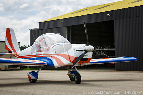 Image of outdoor shot of small plane standing in shed