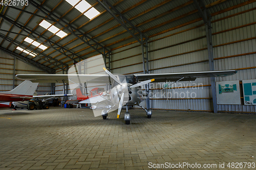 Image of outdoor shot of small plane standing in shed