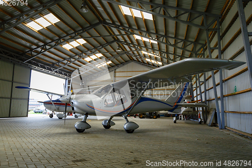 Image of outdoor shot of small plane standing in shed