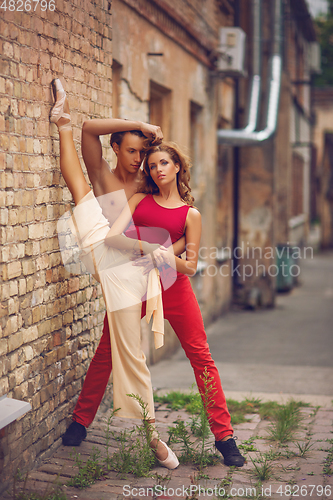 Image of beautiful modern ballet couple dancing in summer outdoors