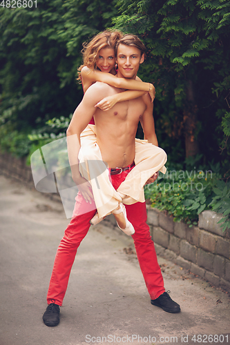 Image of beautiful modern ballet couple dancing in summer outdoors