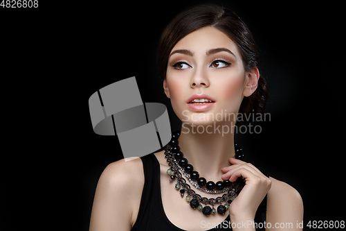 Image of beautiful girl with hairdo on balck background