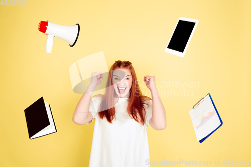 Image of Caucasian young woman\'s portrait on yellow background, too much tasks