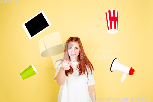 Image of Caucasian young woman\'s portrait on yellow background, too much tasks