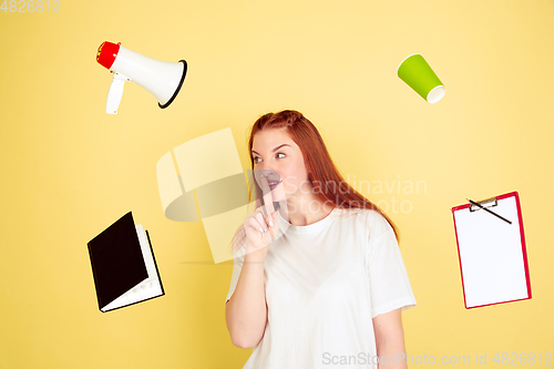 Image of Caucasian young woman\'s portrait on yellow background, too much tasks