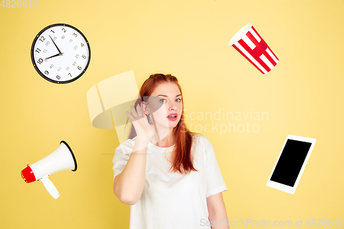 Image of Caucasian young woman\'s portrait on yellow background, too much tasks