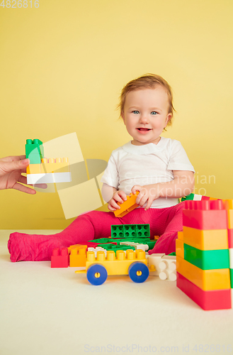 Image of Caucasian little girl, children isolated on yellow studio background