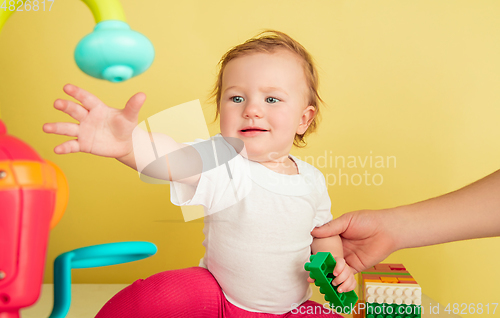 Image of Caucasian little girl, children isolated on yellow studio background