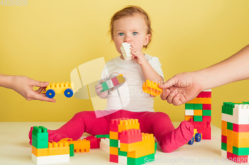 Image of Caucasian little girl, children isolated on yellow studio background