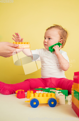 Image of Caucasian little girl, children isolated on yellow studio background