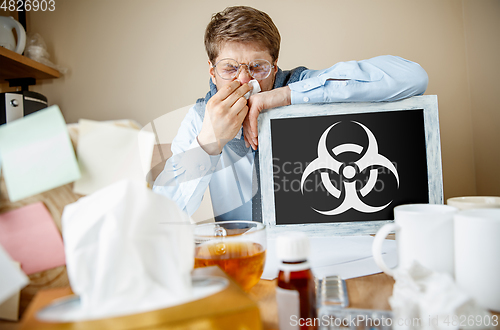 Image of Man feeling ill, has virus infection, fever, headache and sneezing