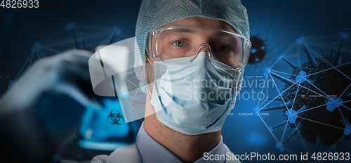 Image of close up of scientist and coronavirus hologram