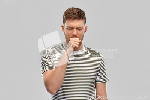 Image of unhealthy young man coughing