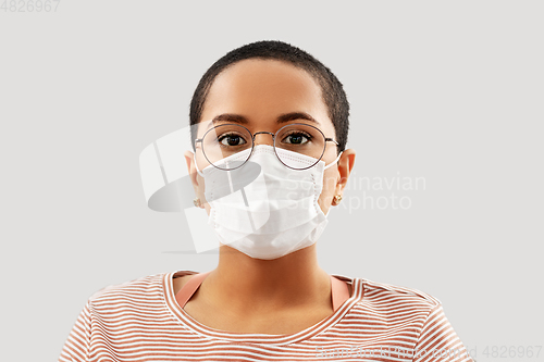 Image of young african american woman in protective mask