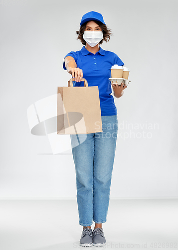 Image of delivery woman in face mask with food and drinks