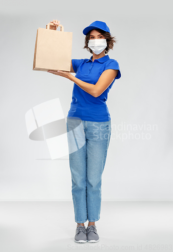 Image of delivery woman in face mask with food in paper bag