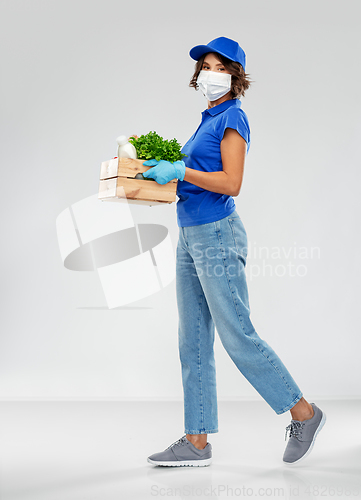 Image of delivery woman in face mask with food in box