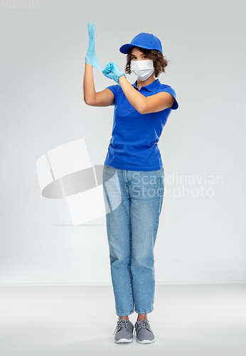 Image of delivery woman in face protective mask and gloves