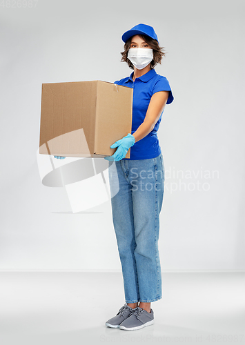 Image of delivery woman in face mask holding parcel box