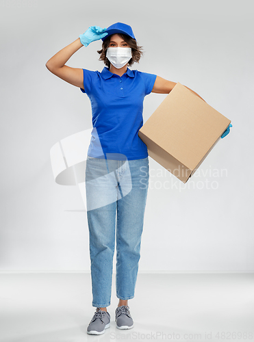 Image of delivery woman in face mask holding parcel box