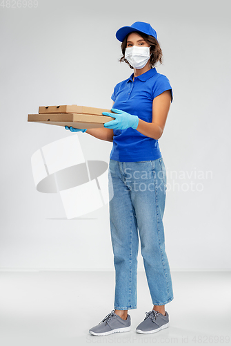 Image of delivery woman in face mask with pizza boxes