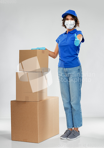 Image of delivery woman in face mask with parcel boxes