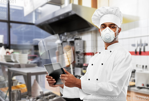 Image of chef in respirator with tablet pc at kebab shop