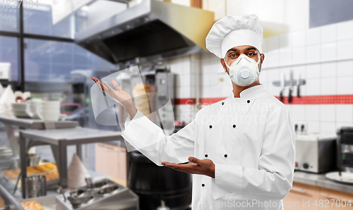 Image of male chef in respirator at kebab shop kitchen