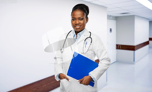 Image of african female doctor with clipboard at hospital
