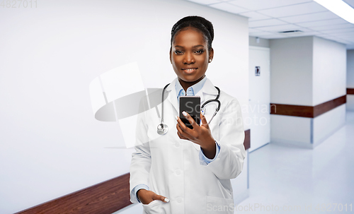 Image of african american female doctor with smartphone