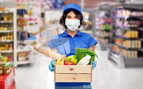 Image of delivery girl in mask with food in box at store