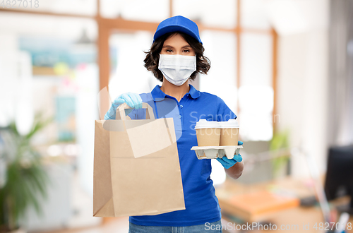 Image of delivery girl in mask with food at office