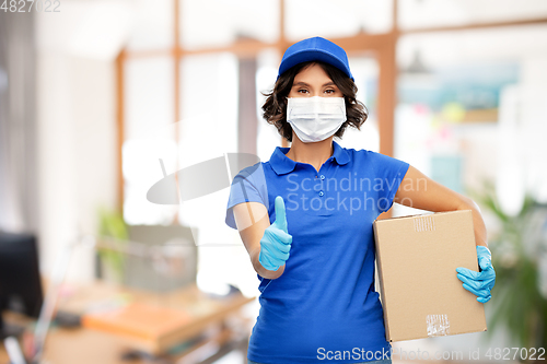 Image of delivery woman in mask with parcel box at office